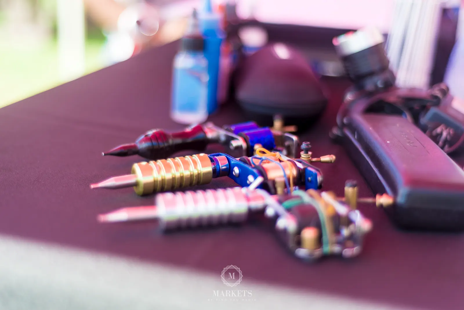 Tattoo machines laid out on the travelling setup